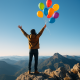 4 Teške životne lekcije koje svi učimo puštajući stvari (svojim tempom) | A person standing on a mountain top, releasing a handful of colorful balloons into a blue sky.