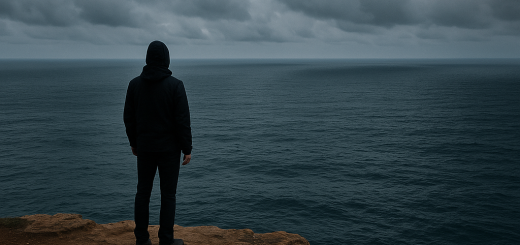 12 Znakova da se držite nečega kada to trebate pustiti | A person standing at the edge of a cliff, looking out at a vast ocean under a cloudy sky.